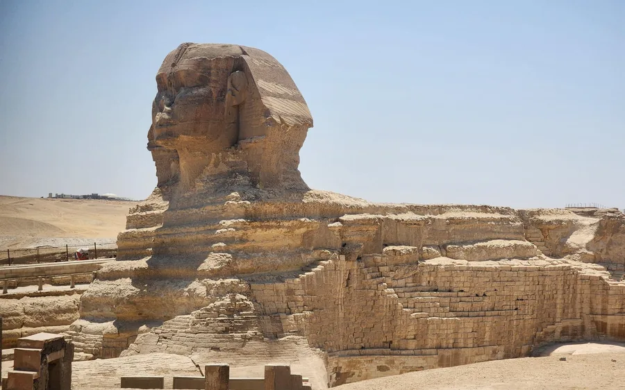 A camel and its rider in front of the pyramids of Giza